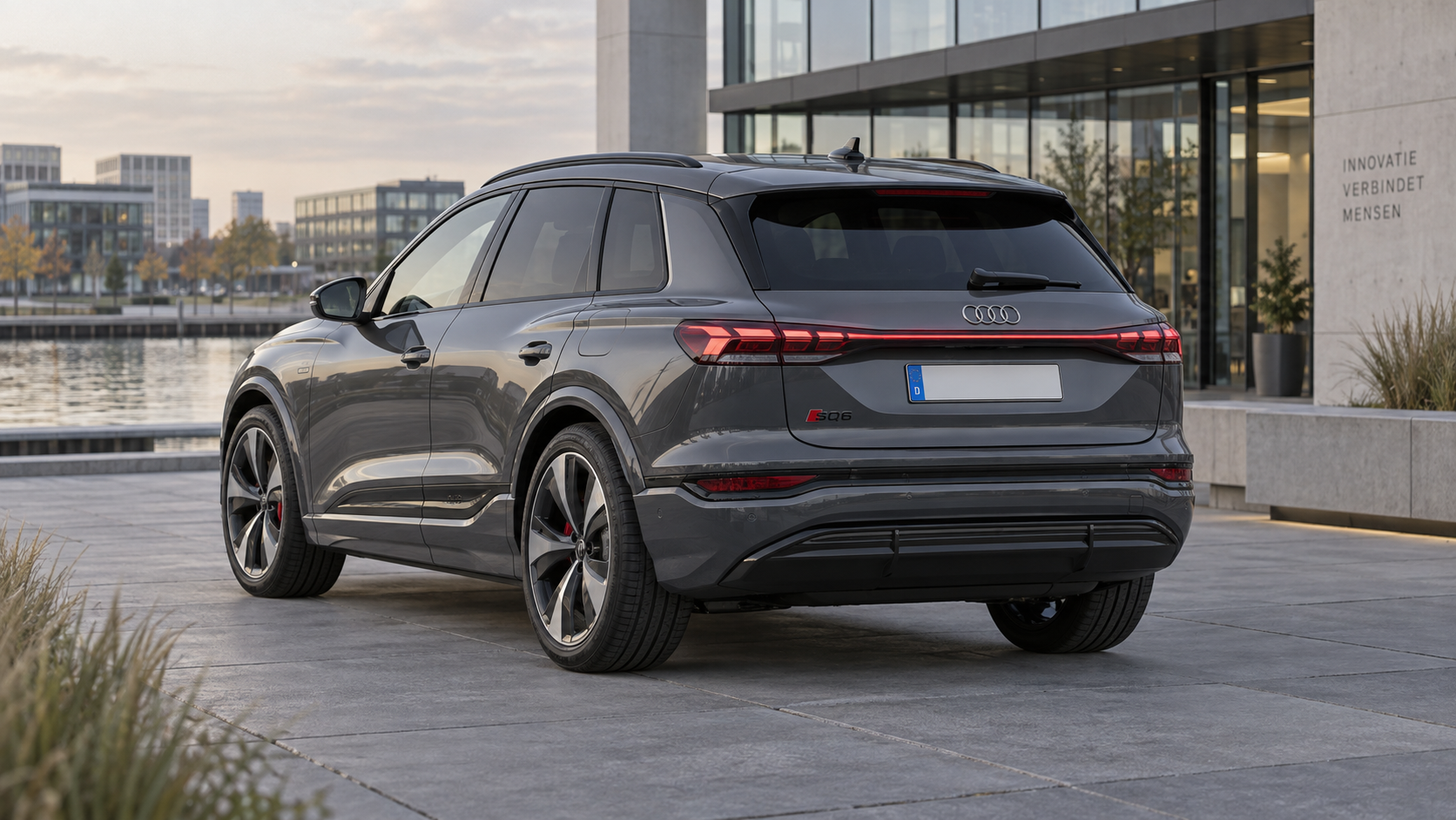 Grijze elektrische Audi SQ6 e-tron SUV, gezien van schuin achter