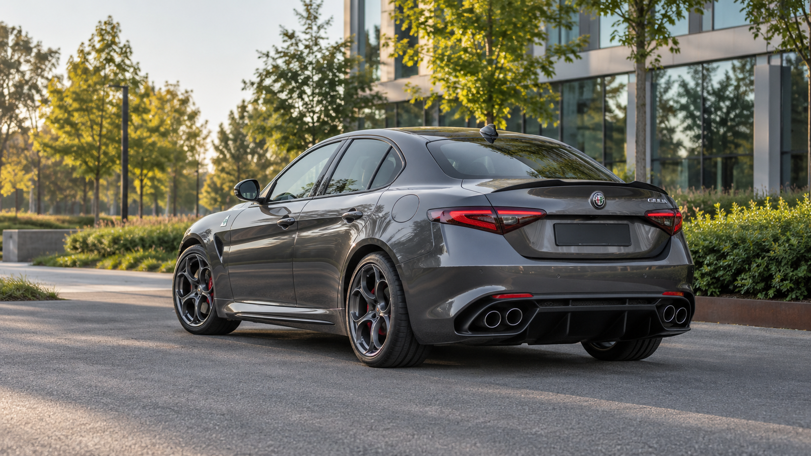 Donkergrijze Alfa Romeo Giulia Quadrifoglio met vier uitlaatopeningen van schuin achteren